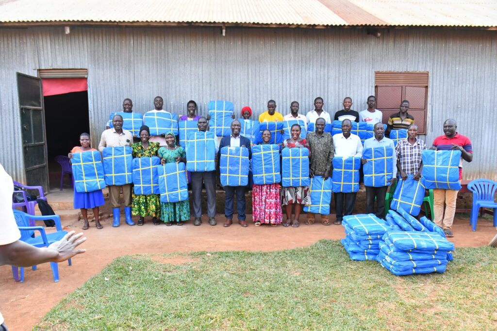 A group photo of soya farmers from three model villages who benefited from the tarpaulin distribution.