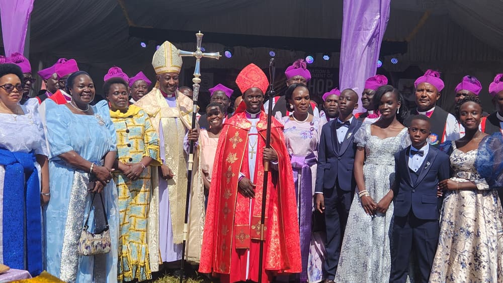 photo moment bringing together Rtd. Maj. Jessica Alupo, The Most Rev. Dr. Stephen Samuel Kazimba Mugalu, and Rt. Rev. Canon Prof. Dr. Grace Lubaale, the 4th Bishop of Busoga, alongside government leaders, cultural leaders, clergy, and distinguished guests from across the country celebrating faith, leadership, and unity in Busoga.