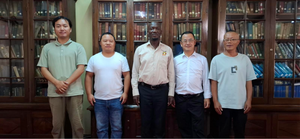 Director General Mr. Mula Anthony of the Busoga Consortium poses with officials from the China–Uganda Agricultural Cooperation Industrial Park during the 2026 chili farming strategy meeting.