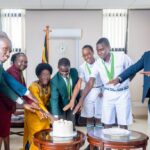 Rt. Hon. Rebecca Kadaga (center) cuts cake with a delegation of students from the Eurasian Schools Debating Championship (ESDC) 2026, celebrating their outstanding achievement on the global stage. PHOTO/Bishop