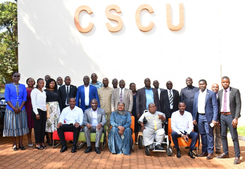 Official group photo of all district LC5 Chairpersons (current and former) during the BCD leadership handover from Bishop Frank Tibagendeka to Mulumba Davidson Kasajja, witnessed by Rt. Hon. Rukia Nakadama and Director General Mula Anthony at Civil Service College, Jinja.